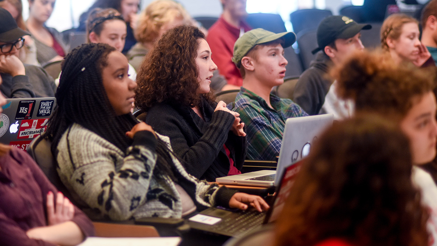 Students listen to a lecture during a college course